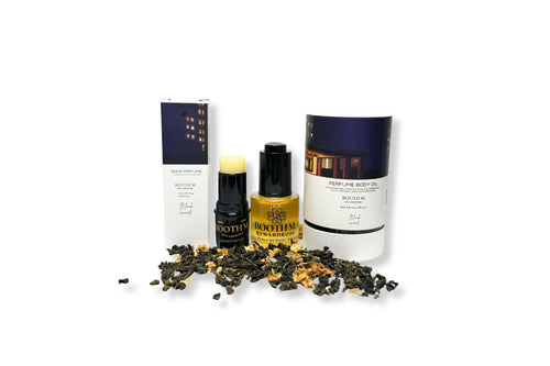 Cosmetic products with tea leaves on a white background